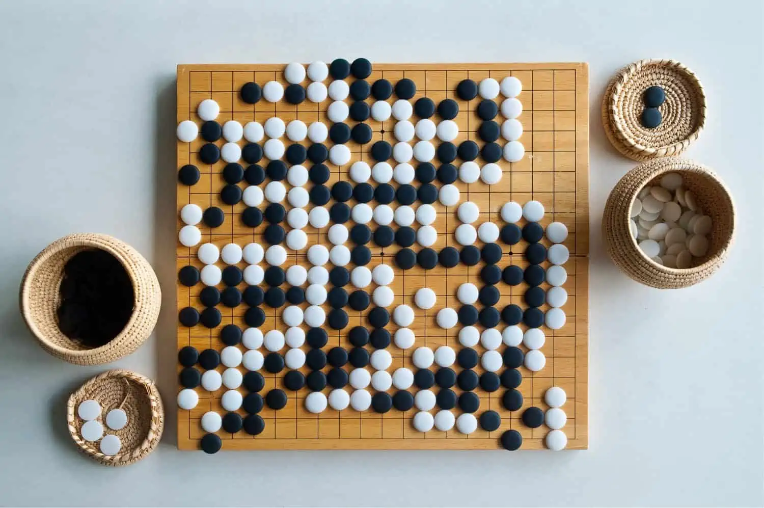 The image depicts a dramatic and symbolic moment showcasing the competition between AlphaGo, an AI program, and a legendary human Go player.